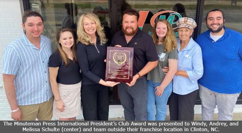 The Minuteman Press International President’s Club Award was presented to Windy, Andrey, and Melissa Schulte (center) and team outside their franchise location in Clinton, NC.